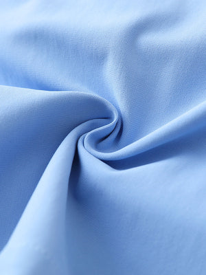 Close-up fabric detail of 4-way stretch performance solid shorts, smooth texture with flexible light blue feel