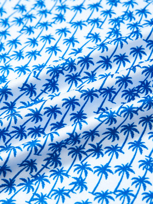 Close-up fabric detail of performance quick dry print golf polos, breathable texture with white palm pattern