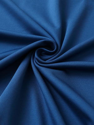 Close-up of blue premium performance polo fabric showing smooth texture.