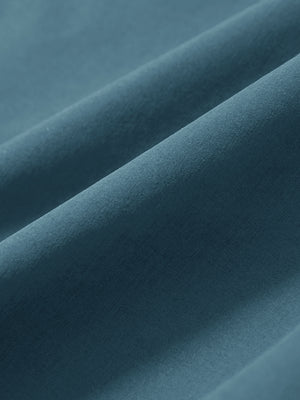 Macro view of the blue stretch soft flat front dress golf shorts fabric, showcasing the smooth texture