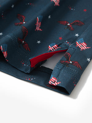 Close-up of the hem vent on the american flag eagle 4 way stretch print collared polo shirt, showing the side split for movement