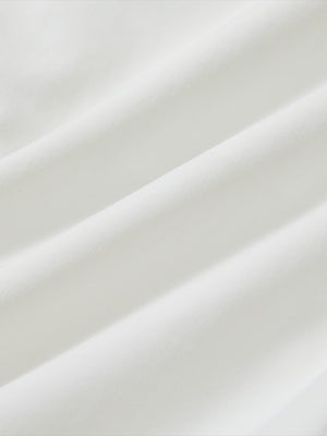 Close-up texture of white flat front flex cotton blend golf shorts fabric showing detailed cotton blend material and weave.