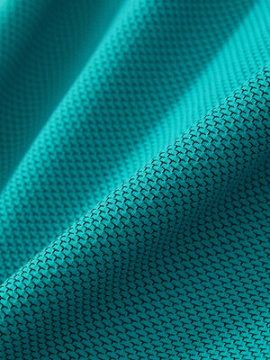 Close-up of the textured jacquard fabric on the turquoise feather weight jacquard polo shirts