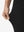 Detail view of stretch fabric on black women's regular fit stretchy golf pants