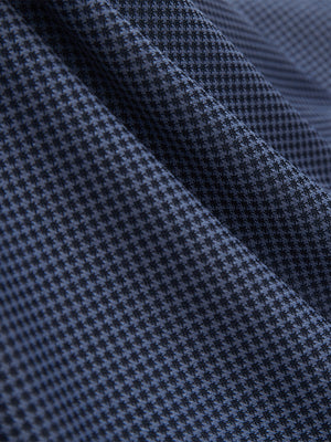 Close-up of the jacquard fabric texture on the blue quick dry ribbed collar golf shirt