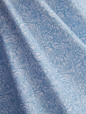 Macro view of the light blue line leaf 4 way stretch print collared polo shirt fabric, showcasing the unique print design