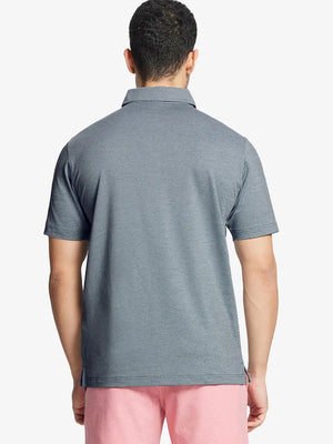 Back half-body shot of model wearing SLATE GREEN HEATHER Ventilated Heather Jacquard Polo