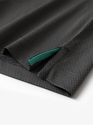 Close-up of side hem slit detail on BLACK Performance Ananas Jacquard Polo