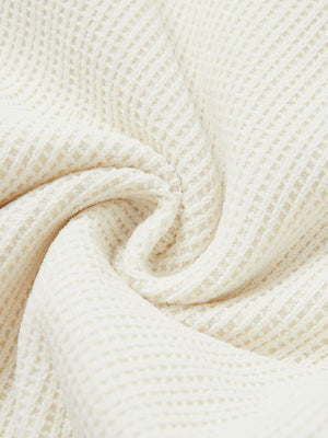 Close-up fabric detail of soft sweatpants with 4 zipper pockets, smooth texture and cozy beige feel