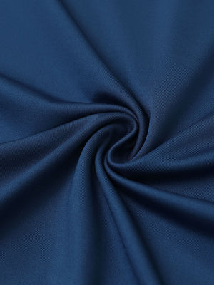Close-up of blue everyday solid jersey polo fabric showing soft knit texture and smooth surface.