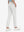 Back lower body view of model wearing the white youth water resistant cotton blend golf pants, highlighting the rear design