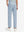 Back lower body view of model wearing the sky blue youth water resistant cotton blend golf pants, highlighting the rear design