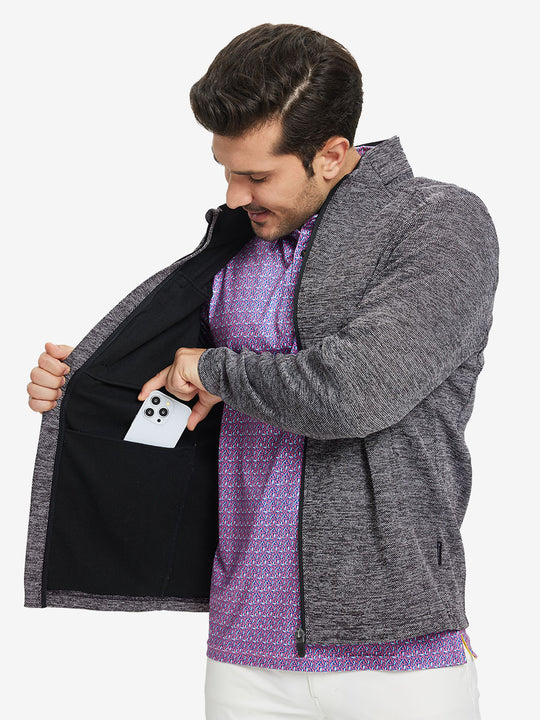 Model front half body lifting jacket, hand in inner pocket, textured insulated winter jacket, black heather.