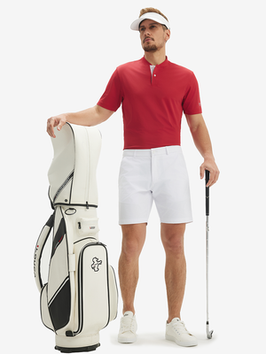 Full-body front view: model in red moisture-wicking short sleeve henley shirt with golf bag.