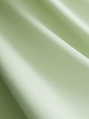 Close-up of light green Moisture-Wicking Short Sleeve Henley Shirt fabric texture.