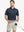 Model in Modern Fit Melange Polo NAVY HEATHER, front half-body holding golf club with relaxed stance.