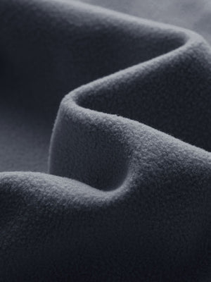 Close-up fabric detail of golf fleece winter puffer jackets, quilted texture and warm feel in dark grey