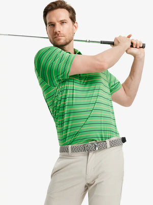 Model in GREEN STRIPE Golf Polo holding club — dynamic front half-body pose